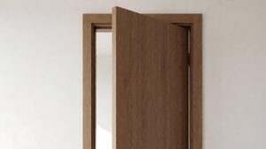 Homeowner tightening a hinge screw on an interior door while marking the rub point on the door edge with a pencil